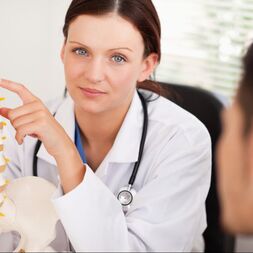 Chiropractor explaining spinal health during a patient consultation