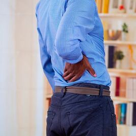 Man holding his lower back in pain